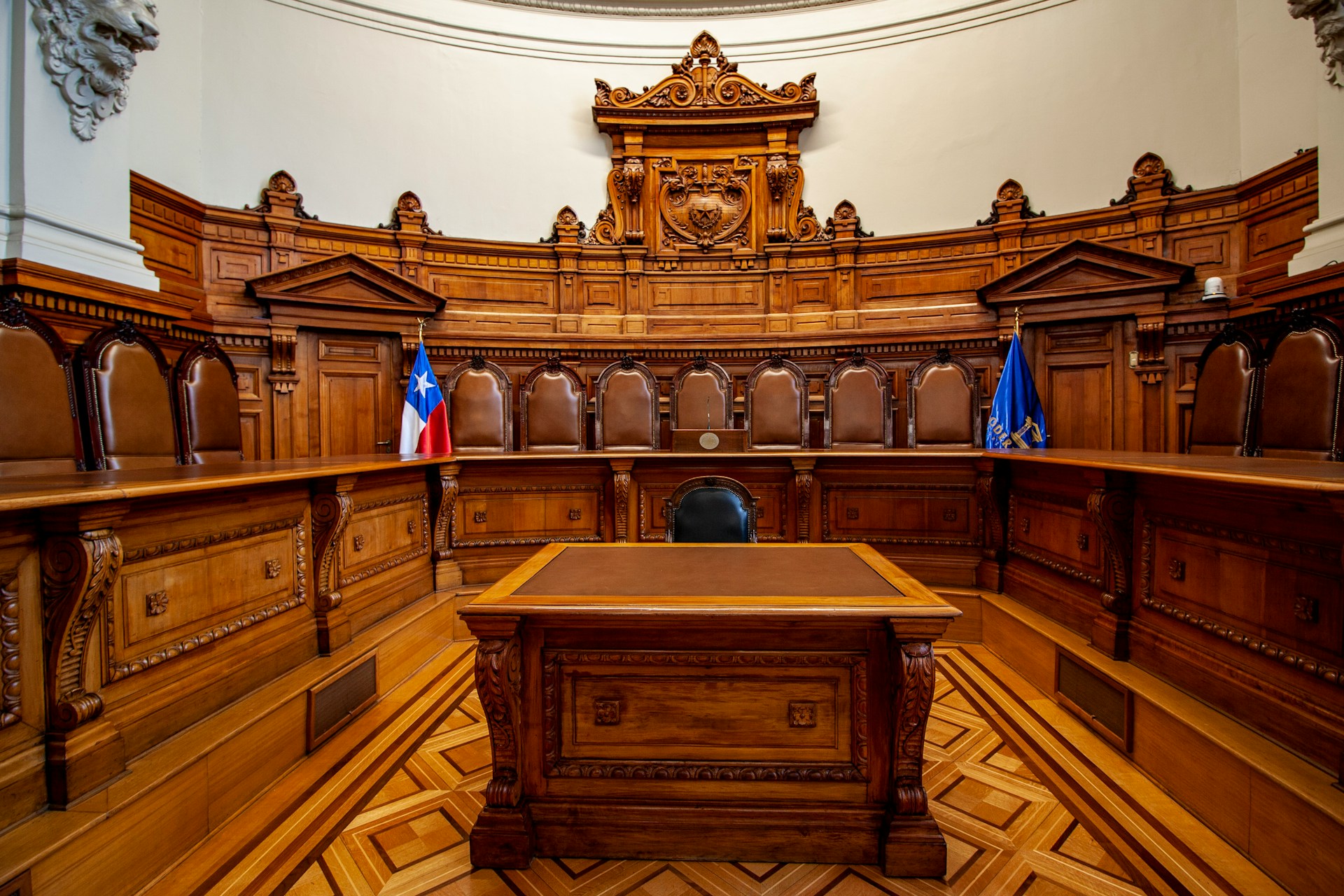 Wood paneled historic courtroom bench in quiet warm light